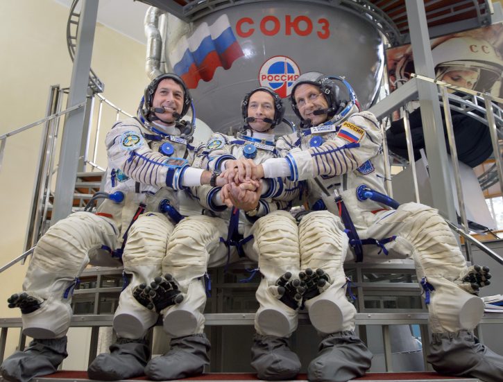 Expedition 49 NASA astronaut Shane Kimbrough, left, Russian cosmonaut Sergei Ryzhikov of Roscosmos, center, and Russian cosmonaut Andrey Borisenko of Roscosmos pose for a group photograph outside the Soyuz simulator ahead of their Soyuz qualification exams, Wednesday, Aug. 31, 2016, at the Gagarin Cosmonaut Training Center (GCTC) in Star City, Russia. Photo Credit: (NASA/Bill Ingalls)
